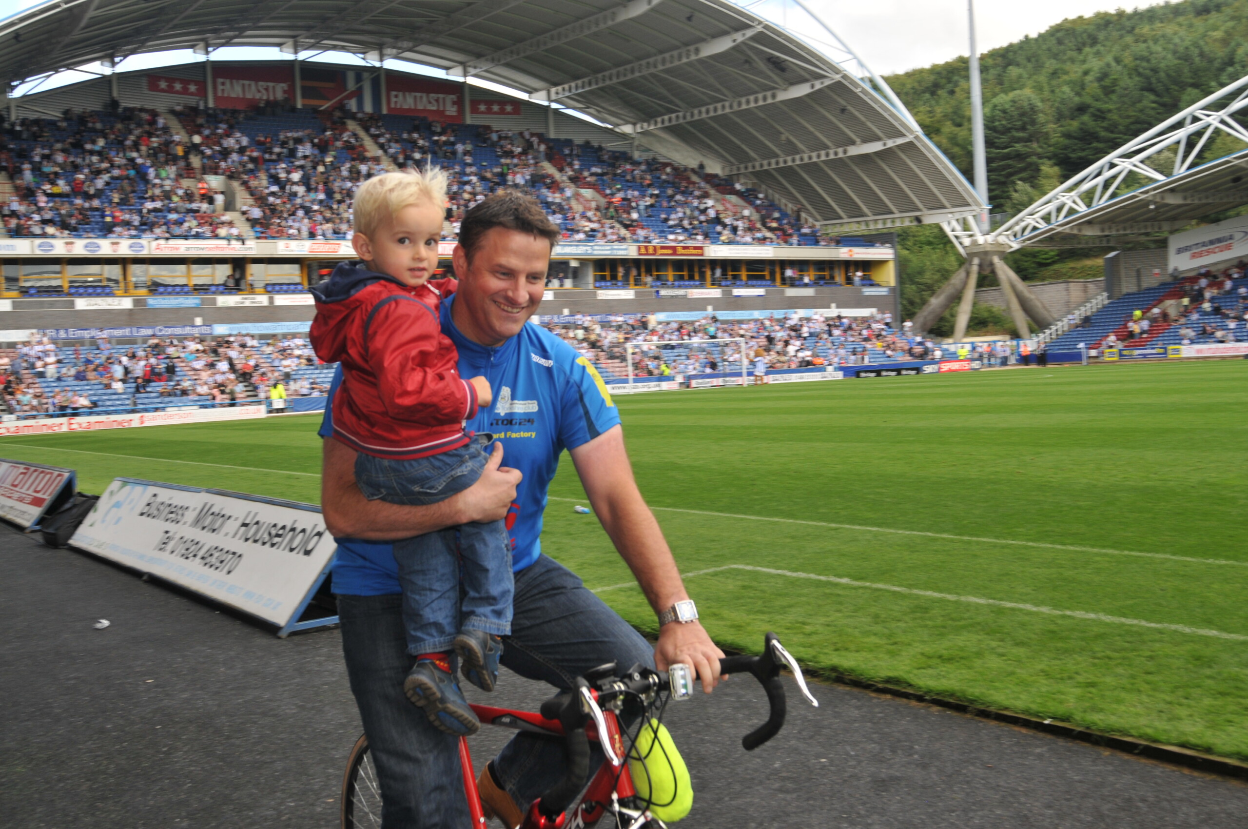 David fryer with hold his son on a bike